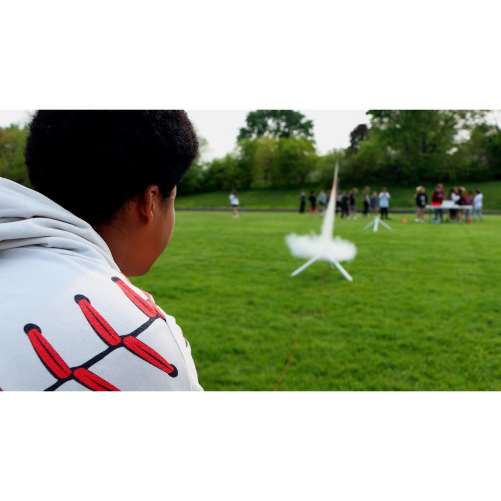 Student watching a model rocket launch